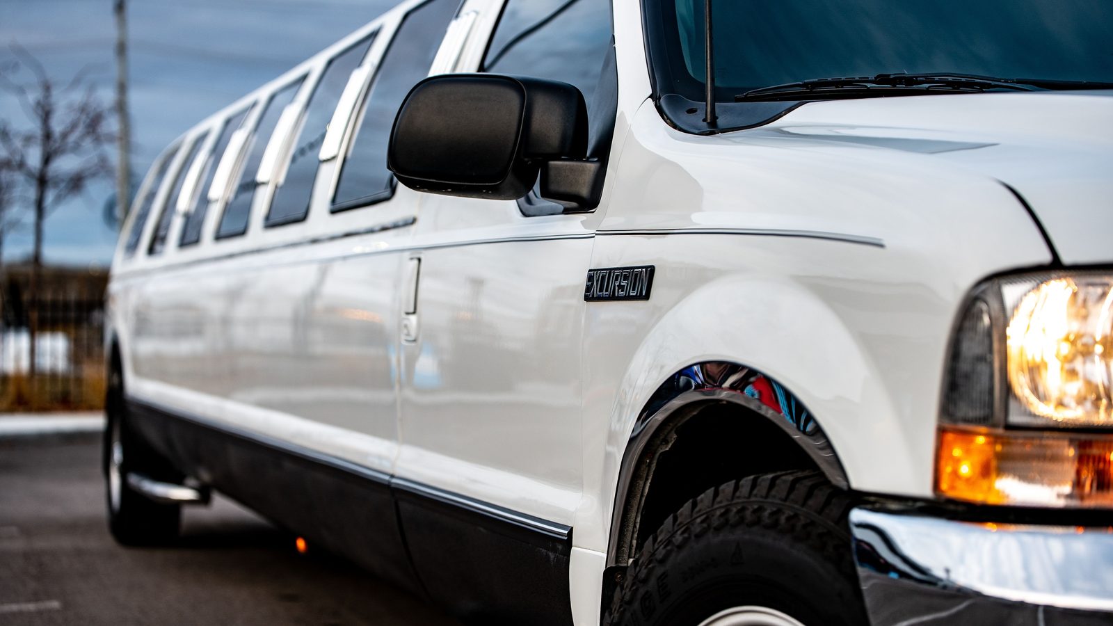 Stretch SUV limousine lit up outside a nightclub