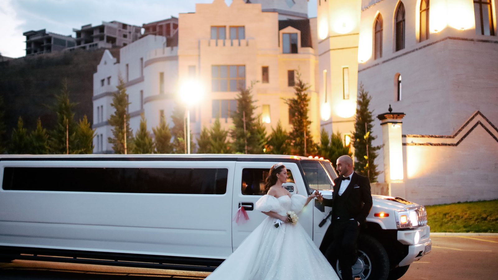 White stretch limousine outside a wedding venue